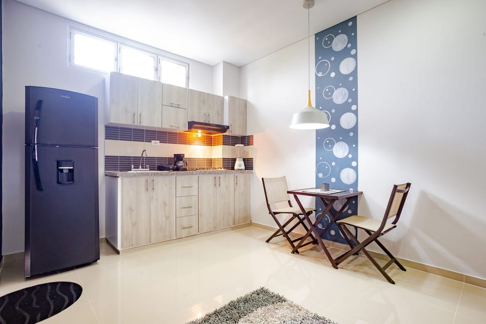 Executive Quadruple Room | Private kitchen | Fridge, toaster, blender, dining table