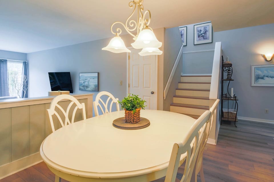 The stairway to the bedrooms on the second floor is located near the dining area.