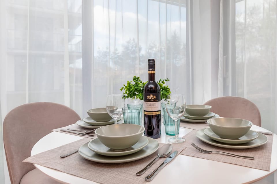 Close-up of a table with round top and kitchenware.