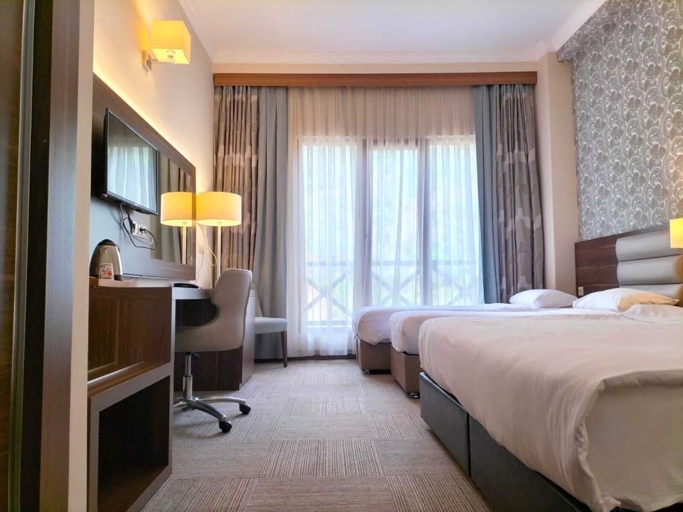 Standard Quadruple Room | In-room safe, blackout drapes