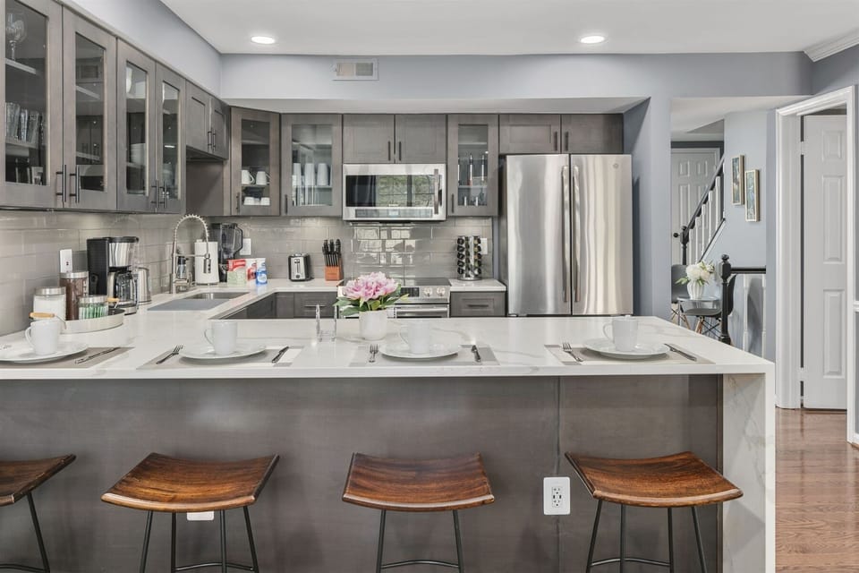 Waterfall peninsula extends four counter stools