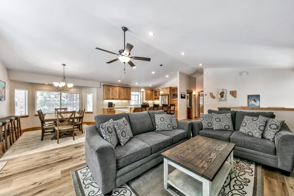 Sink into plush gray sofas in your spacious living room, where warm wood accents and an open floor plan create the perfect gathering spot.