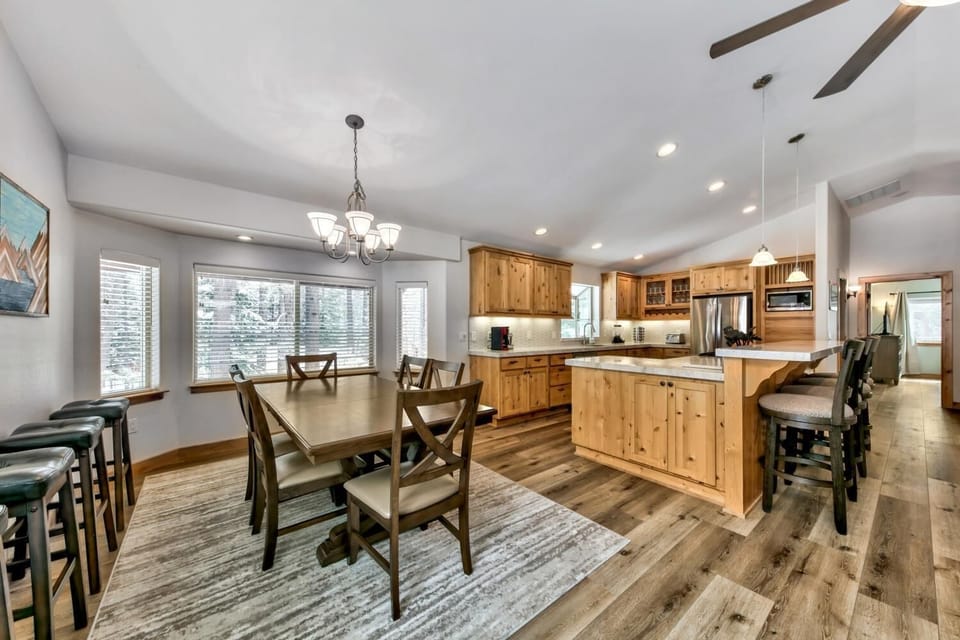 Your open-concept kitchen flows seamlessly into the dining space, featuring warm wood cabinetry and ample counter space for memorable meals together.