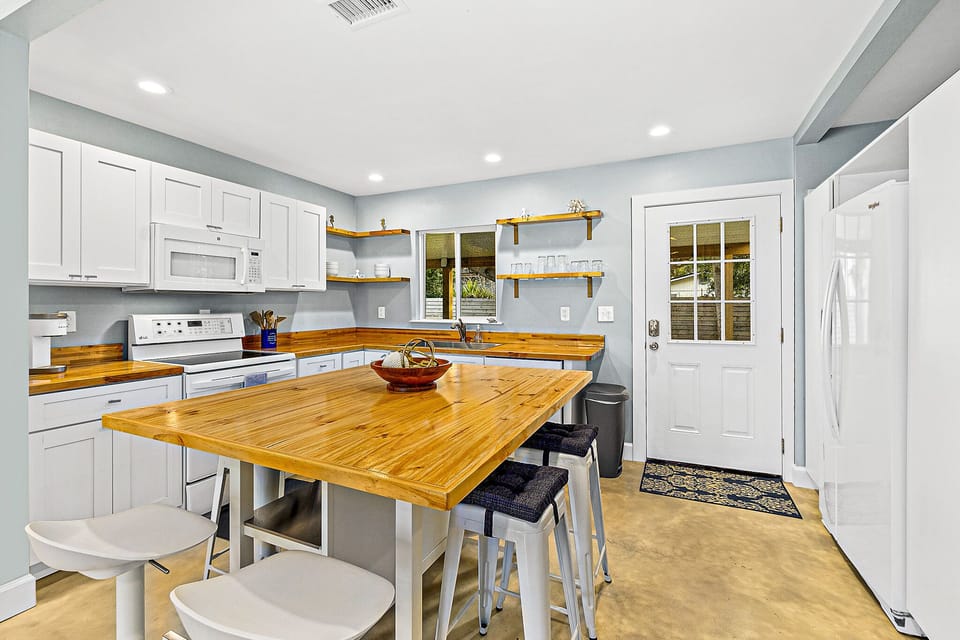 Sit up at the beautiful, polished breakfast bar and keep the chef company