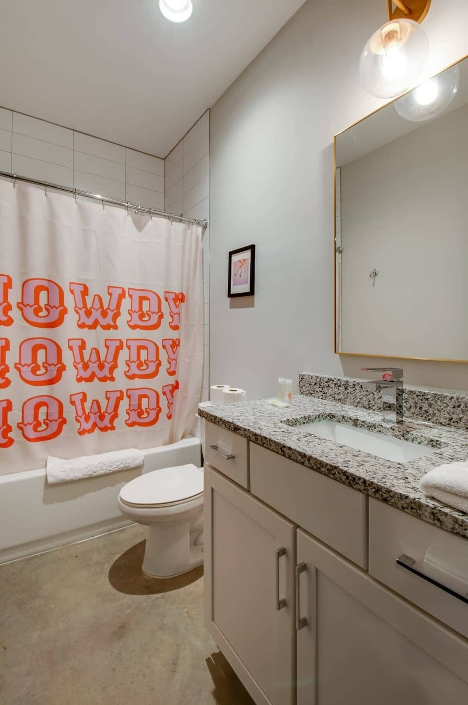 Shower-tub combo and a 'HOWDY' themed shower curtain keep the Nashville spirit alive, even in the bathroom