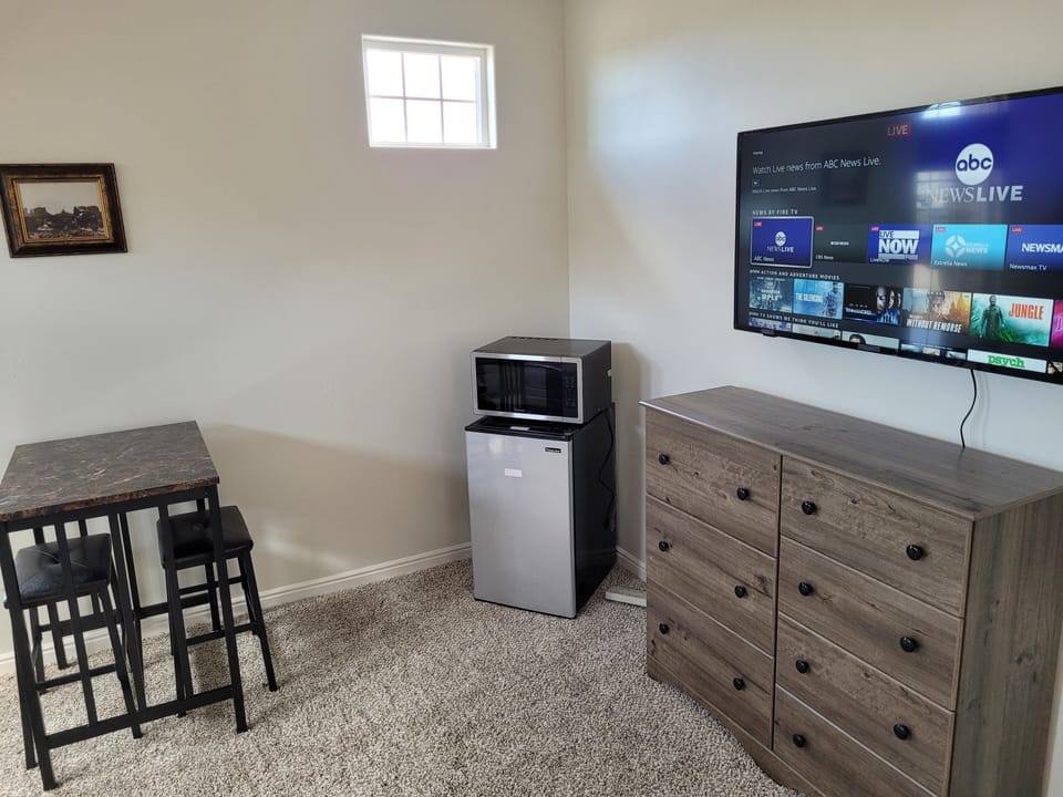 Television, refrigerator and microwave oven. Dining table and dresser for guests