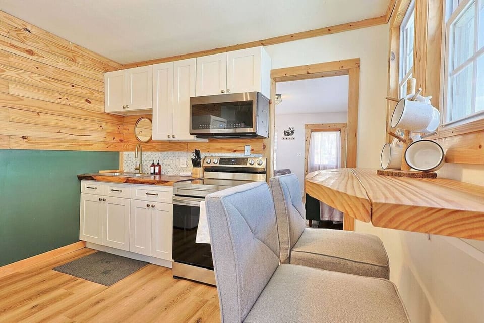 Kitchen: Sleek design with modern appliances and charming wood accents for culinary adventures!