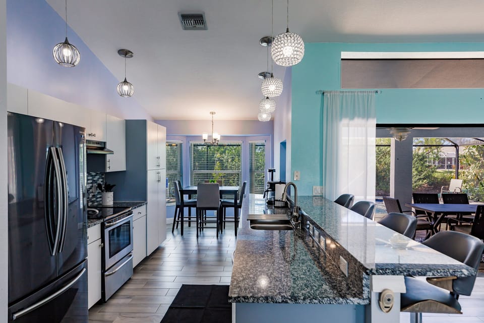 Endless granite counters, with coffee pot, blender, microwave, toaster oven.