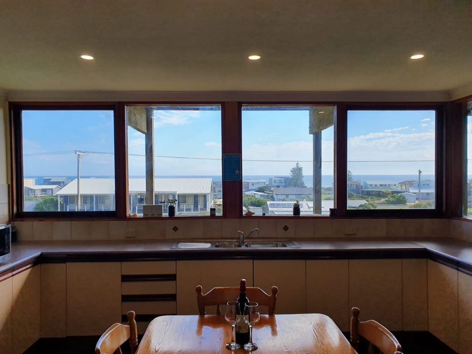 Functional Kitchen with Sea Views. Bright and well-maintained kitchen and dining space with ocean glimpses—perfect for shared meals and morning coffees.