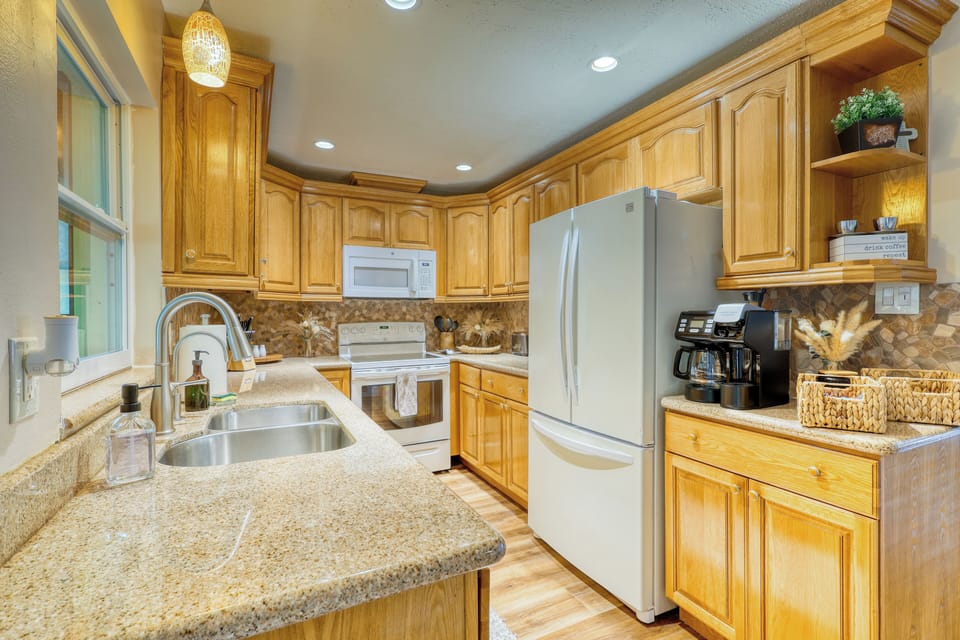 Modern kitchen with full appliances, cookware, and sleek design