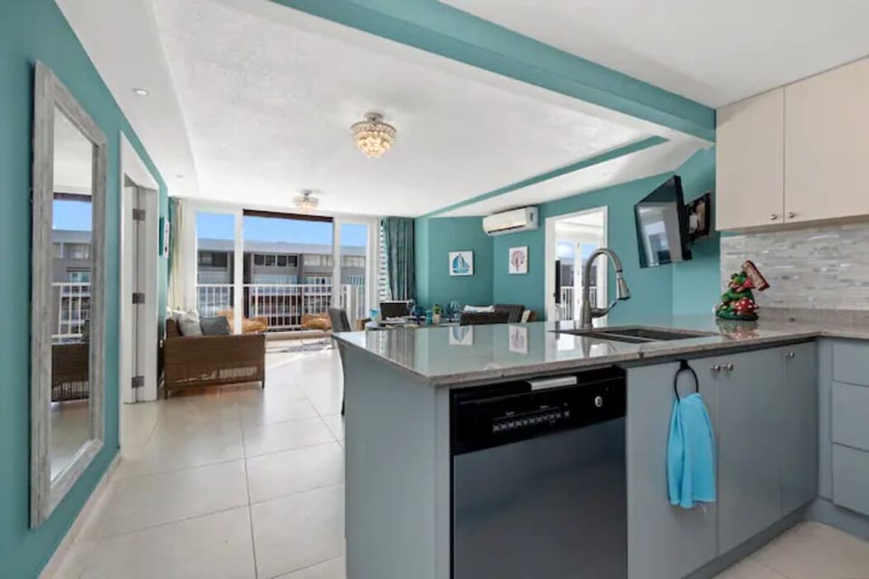 Modern stainless-steel appliances and stylish design define the kitchen