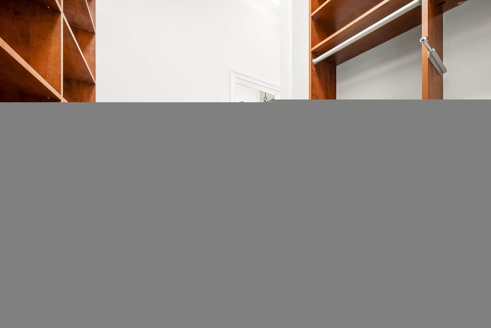 His & Hers walk in Closets full of Cabinets