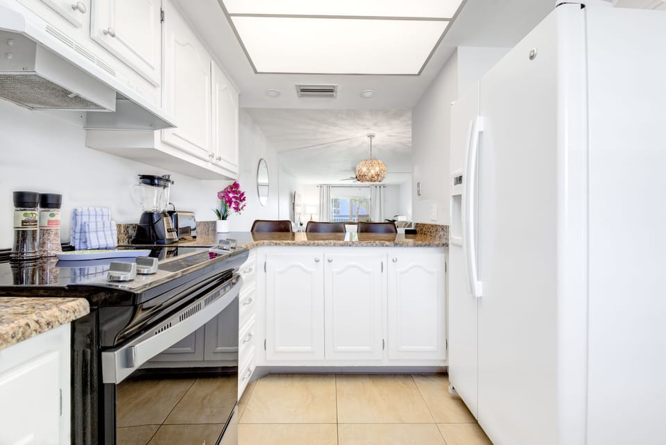 Sleek white kitchen with modern appliances and plenty of counter space