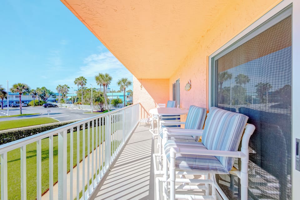 Spacious balcony with comfortable seating and a peaceful tropical view