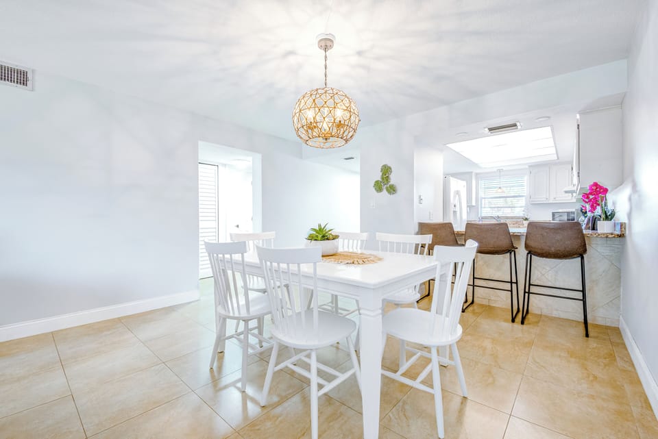 Elegant dining area with a modern chandelier and a fresh inviting feel