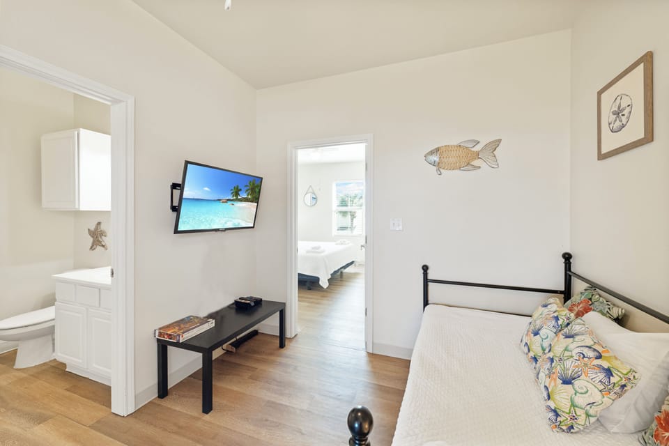 Your coastal-themed bedroom features charming nautical décor and a wall-mounted TV for relaxing evenings after exploring.
