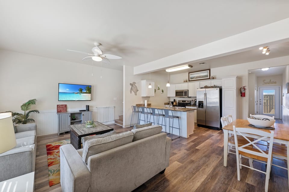 Your bright open-concept space seamlessly blends modern comfort with coastal charm, featuring a full kitchen and cozy living area perfect for relaxing.