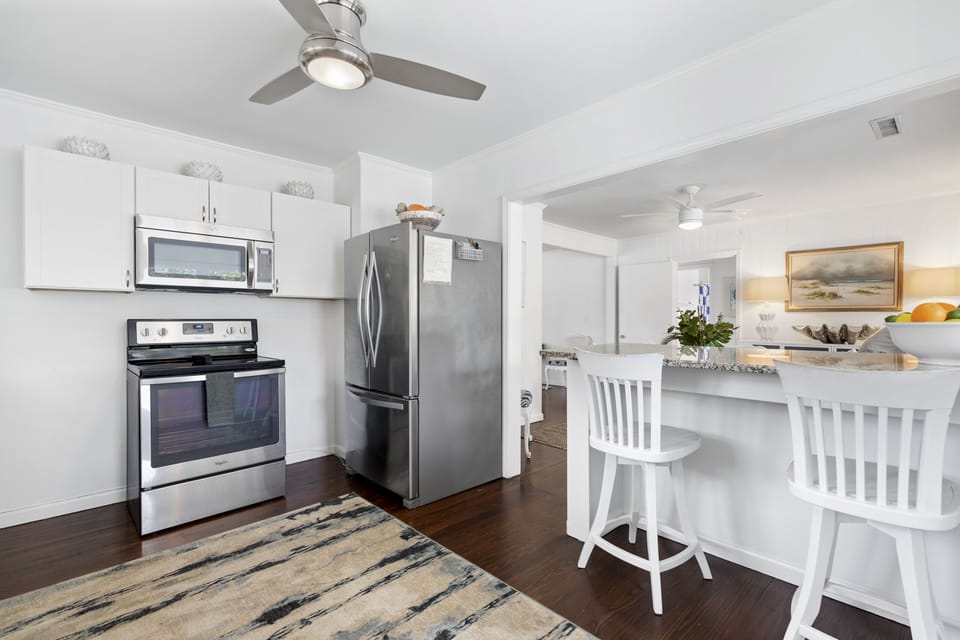 Airy Kitchen highlighting ample counter space, fully equipped kitchen — steps from the beach