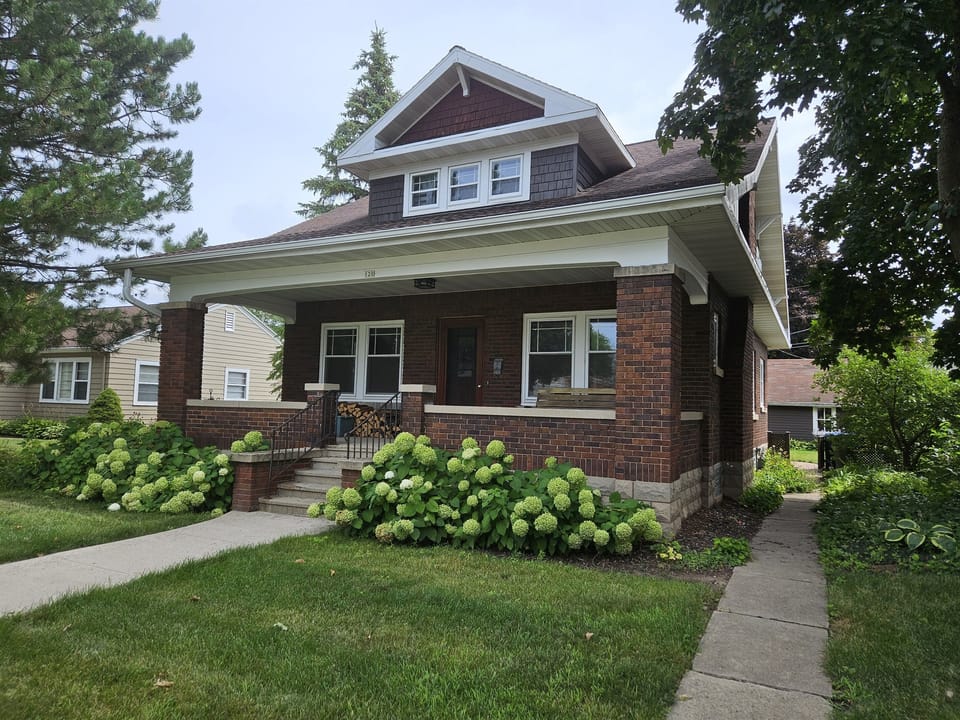 Watch the neighborhood and the weather while sitting on the large covered porch
