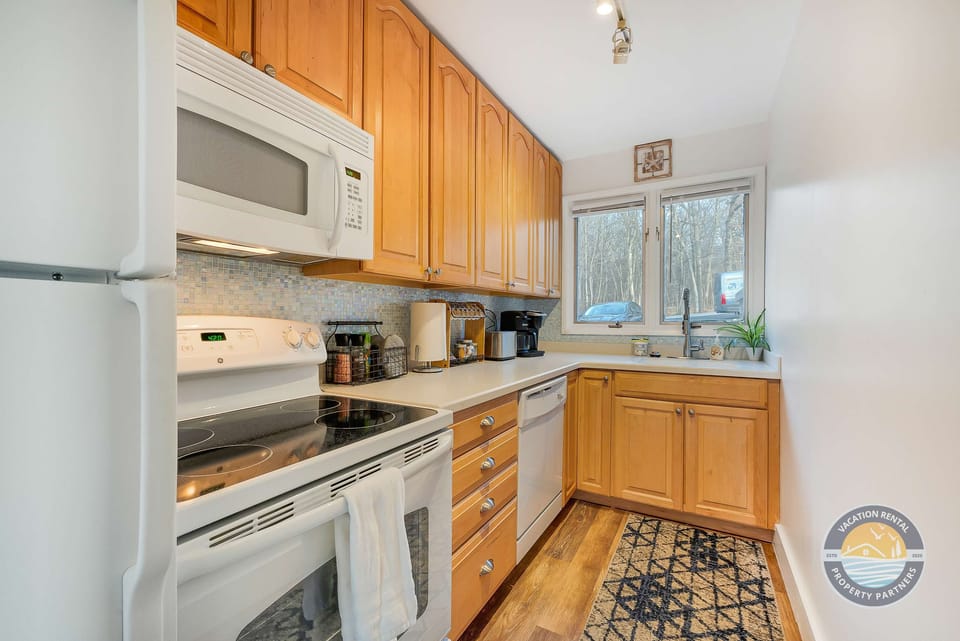Microware, stove, oven, dishwasher, fridge, freezer, and other necessary amenities. Fully stocked kitchen with everything you need to cook at home.