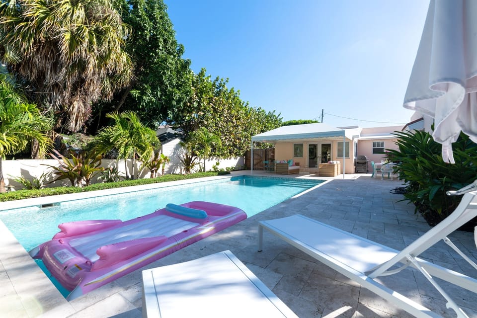 With entrance through the Florida room to the perfect outdoor oasis. Relax under the covered patio and outdoor furniture. Outdoor dining table for 8. Pool loungers and BBQ grill. The stunning large pool is heated (daily pool heater fee is charged).