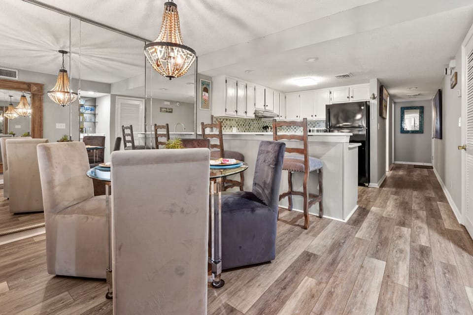Glass dining table beside the kitchen island at Coastal Shores C2 in Ocean Drive, North Myrtle Beach