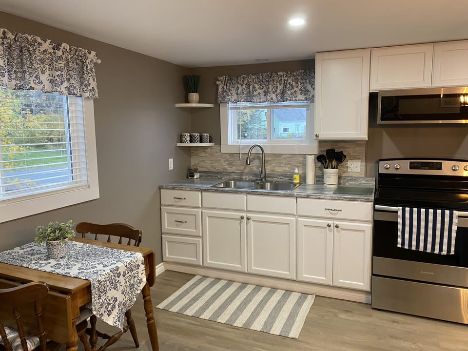 Kitchen complete with fridge, microwave, full sz. range, keurig duo coffee pot. 
