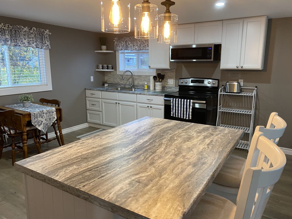 Kitchen island that separates kitchen and living room area. 