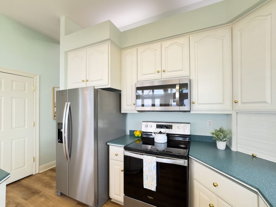 New stainless steel kitchen appliances and fully stocked kitchen.