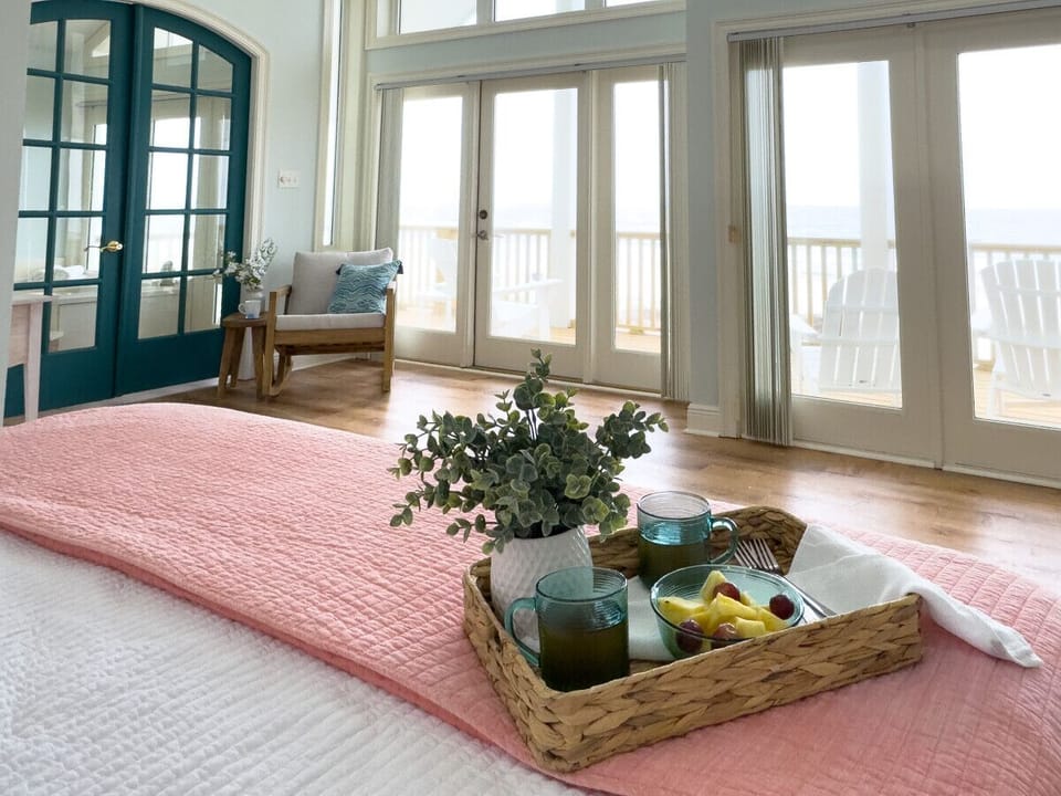 Luxurious primary suite with endless ocean views and a private deck