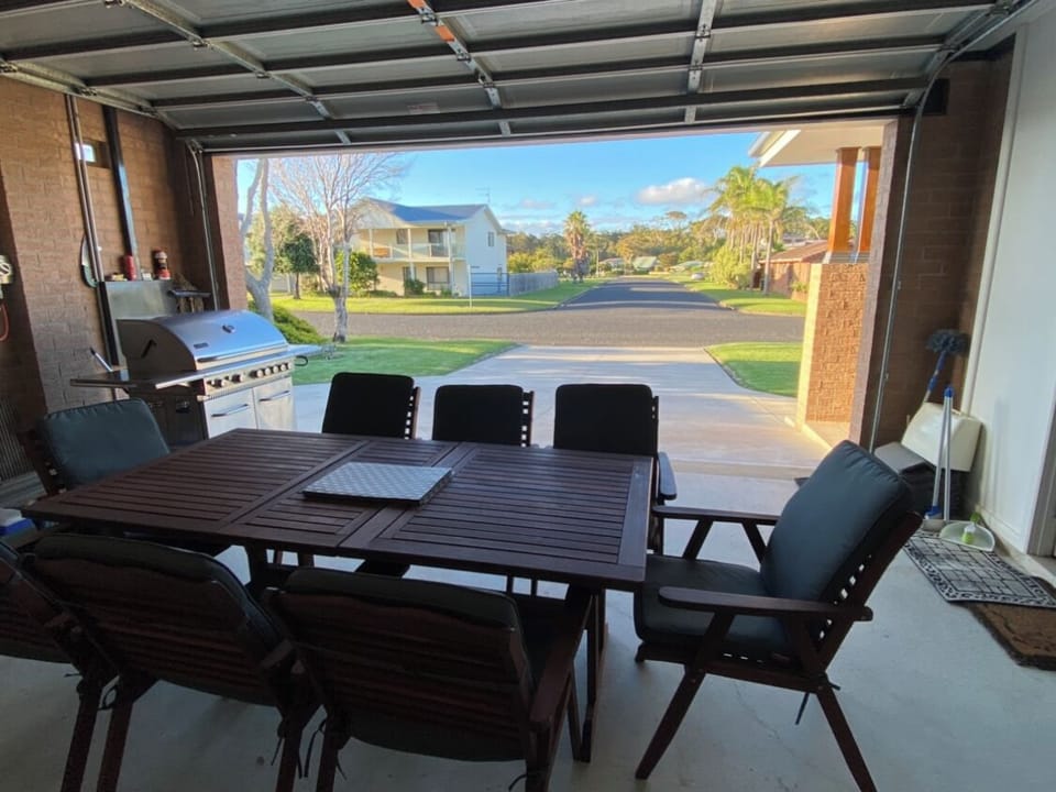 Large table setup in the garage, sit back enjoy a BBQ and the quiet street view.