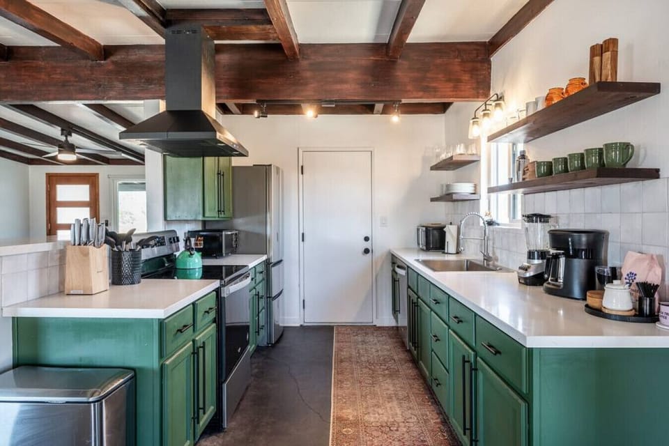 Fully equipped kitchen with new appliances and a deep green finish