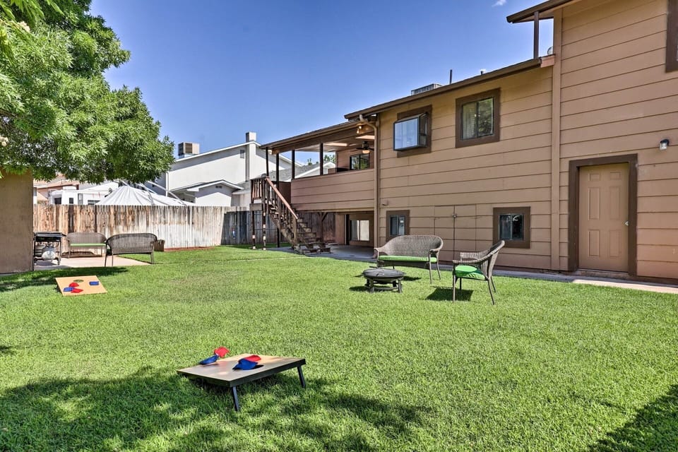 Large, fenced back yard with outdoor games and seating