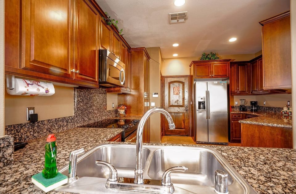 This well-equipped kitchen includes a full-size refrigerator, stove, microwave, and coffee maker