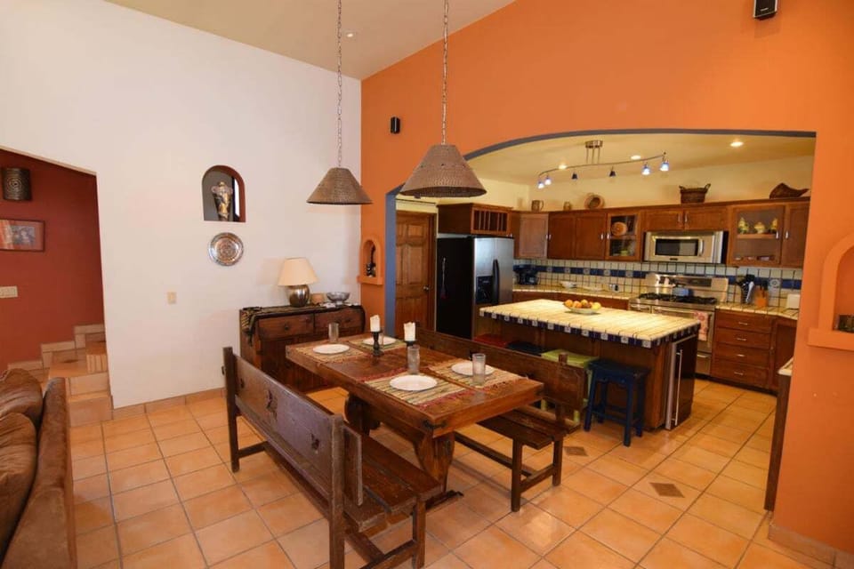 The kitchen at Casa Welch is equipped with modern, gourmet appliances including a refrigerator, stove, microwave, and a cappuccino machine—perfect for preparing meals during your stay