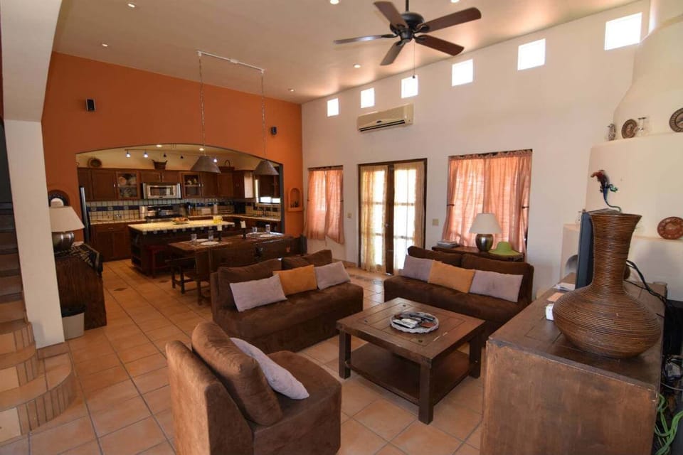 The living room at Casa Welch features comfortable seating, a propane fireplace, and a flat-screen TV with DirecTV and surround sound for movie nights .
