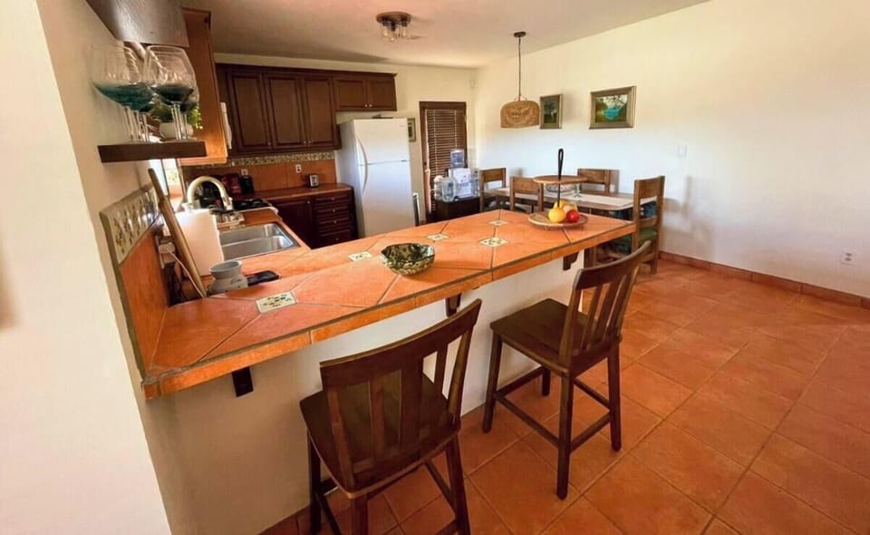 Gather around the island. This kitchen at Casa Dooley vacation rental inside Los Medanos at El Dorado Ranch in San Felipe Baja California Mexico features a central island — perfect for meal prep, casual dining, or hanging out while someone cooks.