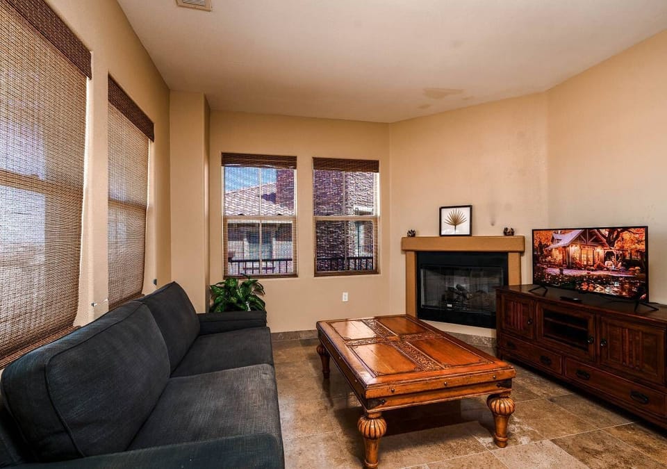 The upstairs living room features a flat-screen TV and cozy fireplace — located on the second level near the chef's kitchen and huge patio overlooking the golf course .