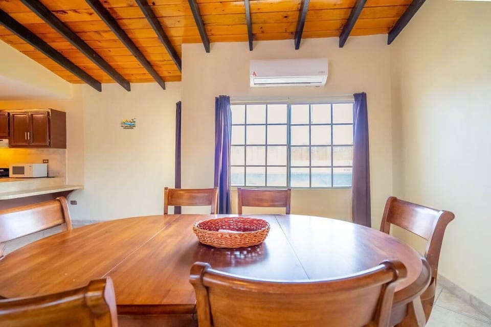 The dining table seats four and is located between the kitchen and living room — perfect for quick meals and morning coffee before heading to the beach.