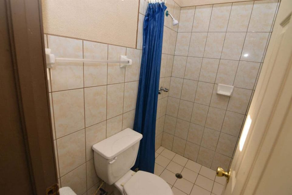 The private full bathroom features a stand-up shower and is stocked with fresh towels