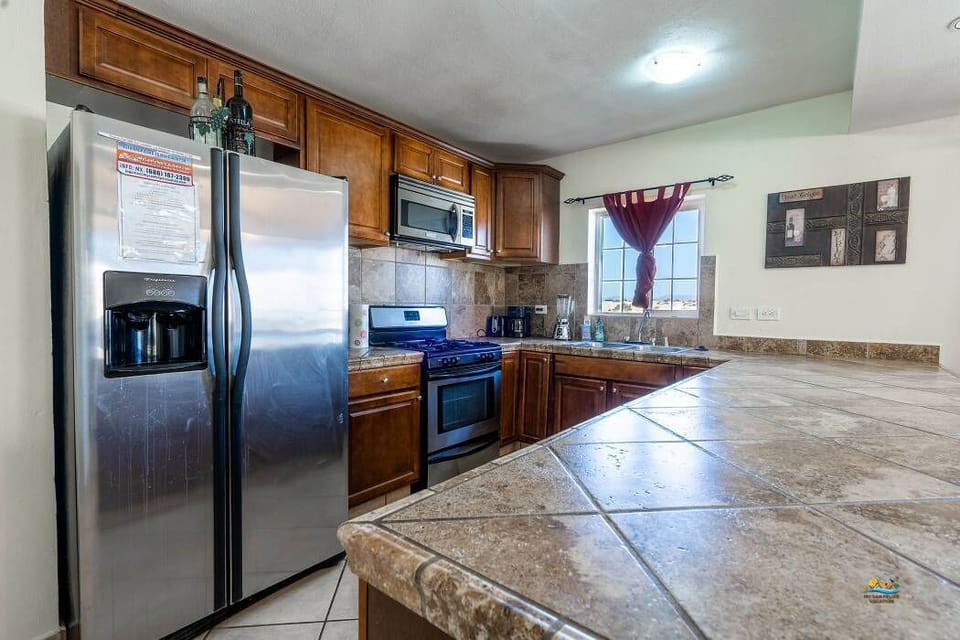 Cook with ease in the full kitchen of Casa Monterrey in La Hacienda San Felipe Baja California MX — stainless steel appliances included.