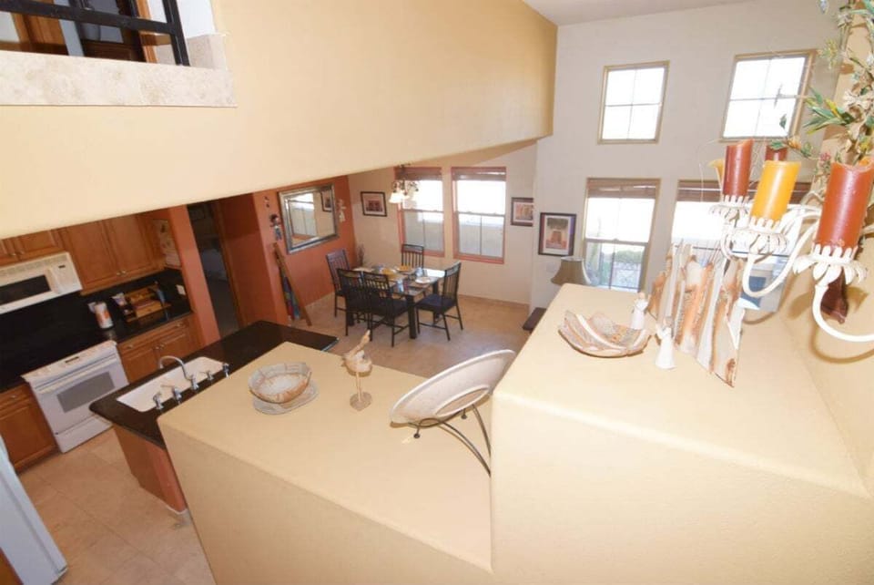 Staircase leading from the main living area to the second-floor bedrooms and balcony — located near the kitchen for easy access.