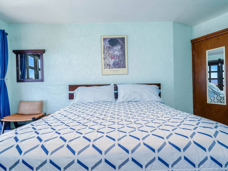 A spacious master bedroom featuring a comfortable king-size bed and elegant decor for a restful vacation experience.