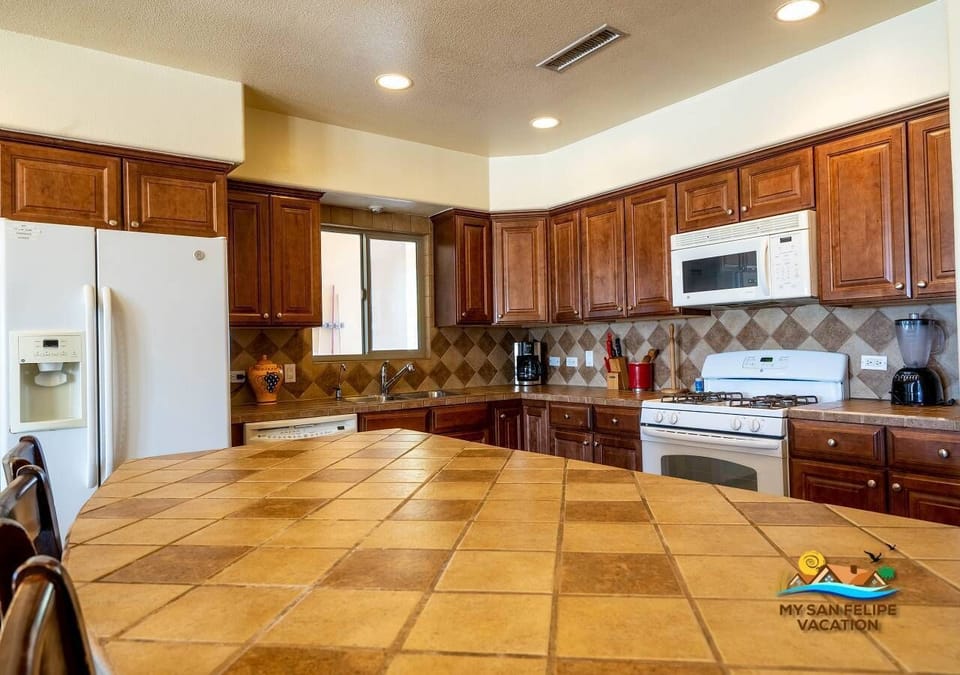 Open kitchen island with bar stools and extra counter space. Perfect for casual meals or morning coffee