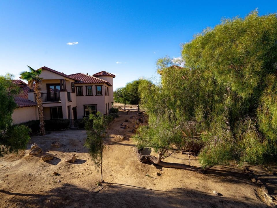 The back patio features a picnic table and chairs — a quiet outdoor space to enjoy meals or relax after a day at the nearby community pool.