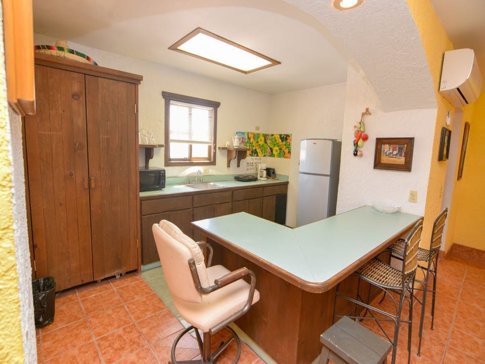 The kitchen includes a dishwasher and microwave — part of this 2‑bedroom, 2‑bath vacation rental with a private balcony .