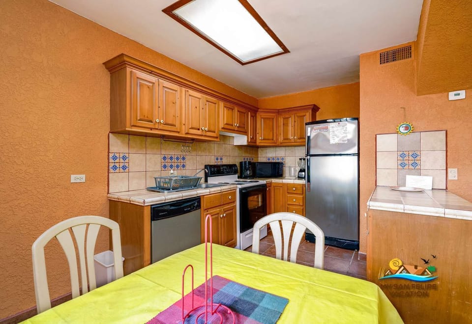 An open-concept view highlighting the seamless flow between the dining space and the kitchen, perfect for enjoying home-cooked meals and entertaining in a modern setting.