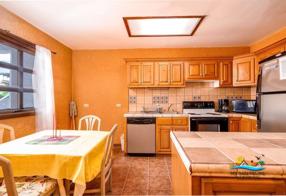 An open-concept view highlighting the seamless flow between the dining space and the kitchen, perfect for enjoying home-cooked meals and entertaining in a modern setting.