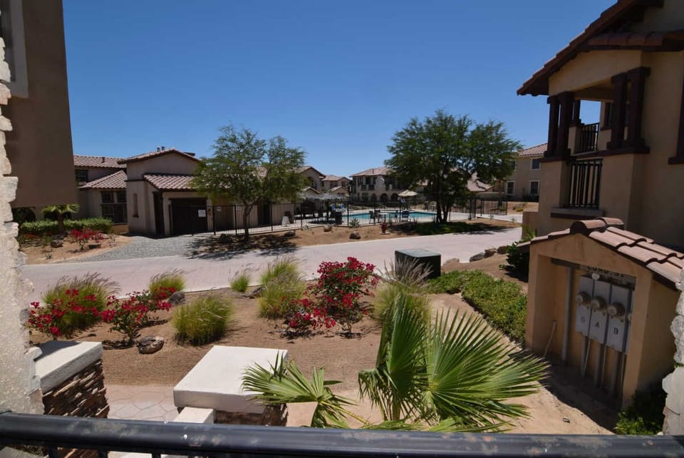 From the front entrance, you can see the community pool just steps away — with the pool visible through sliding glass doors in the living area.


Next