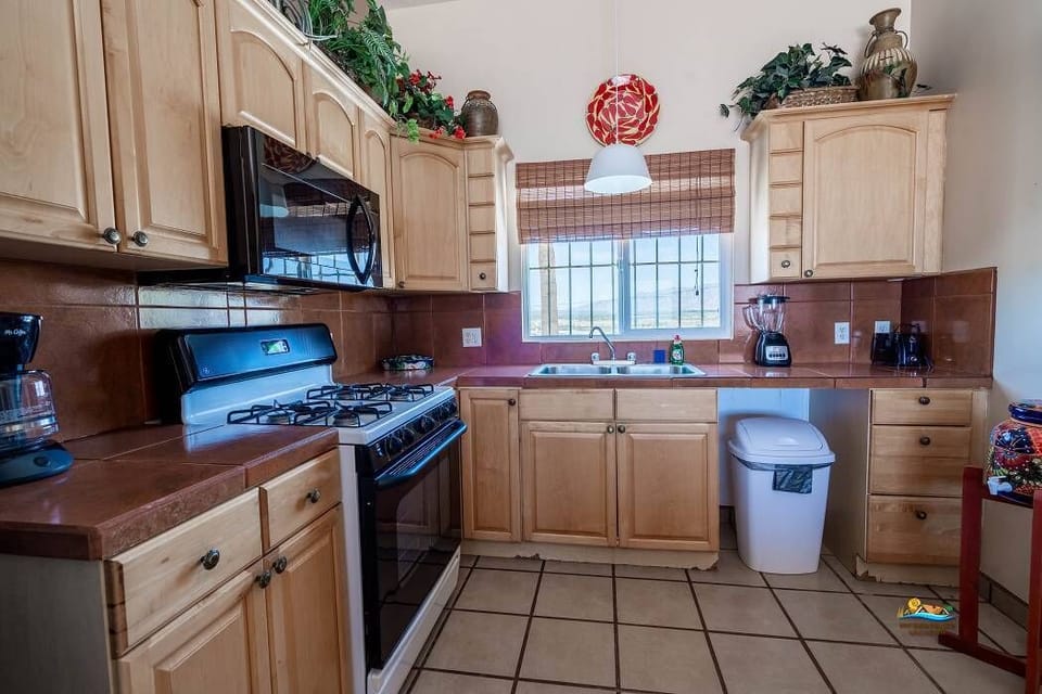 This Casita de Playa kitchen includes a full-size refrigerator, oven, microwave, coffee maker, and all essential cookware — everything needed to prepare meals during your stay